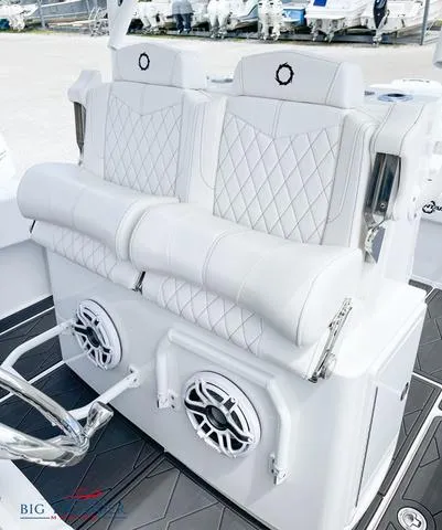 Slide: The Image of 2023 Fountain 34 TE boat with white cushioned seating and built-in speakers. - 10