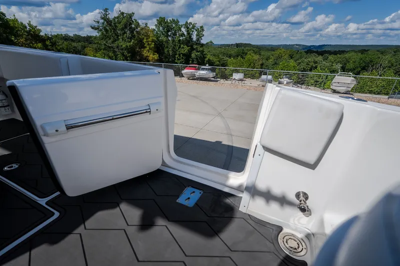 Slide: The Image of 2023 Fountain 34 Tournament Edition boat deck with open door, scenic outdoor view. - 86