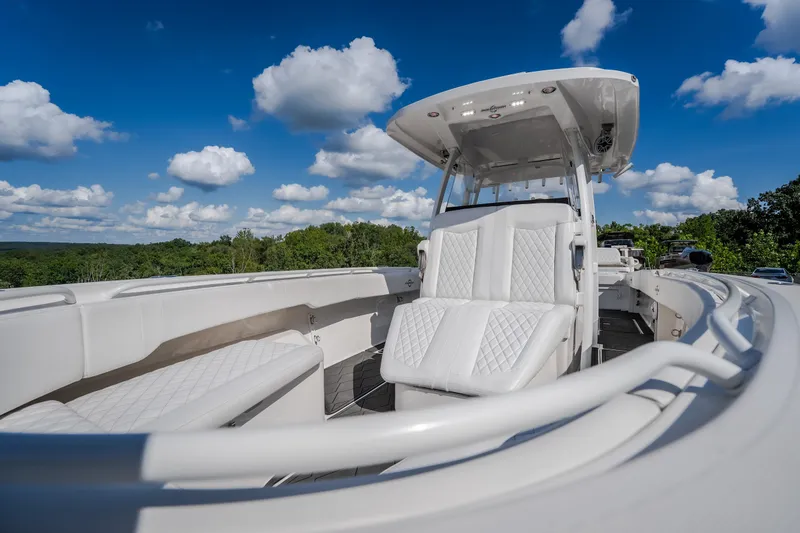 Slide: The Image of 2023 Fountain 34 Tournament Edition boat with white seating under a blue sky. - 73