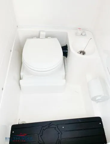 Slide: The Image of 2023 Fountain 34 TE boat bathroom with toilet and sink. - 14