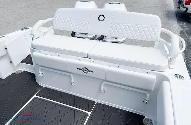 Slide: The Image of 2023 Fountain 34 TE boat with white cushioned seating and diamond-stitched backrest. - 3