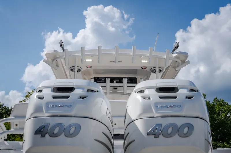 Slide: The Image of 2023 Fountain 34 Tournament Edition boat with dual 400 Verado engines under a blue sky. - 37