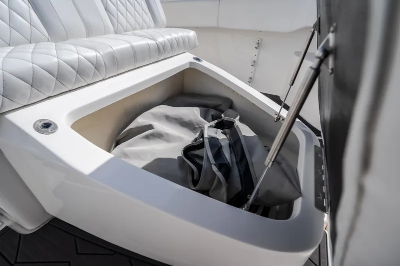 Slide: The Image of Storage compartment on 2023 Fountain 34 Tournament Edition boat with cushioned seating. - 64