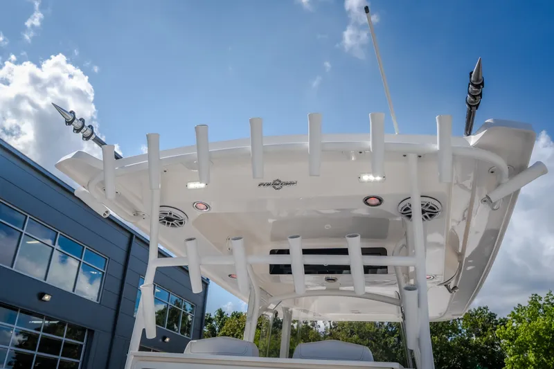 Slide: The Image of 2023 Fountain 34 Tournament Edition boat with rod holders and speakers under a clear sky. - 82