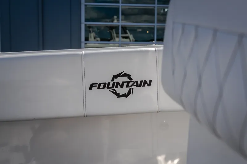 Slide: The Image of 2023 Fountain 34 Tournament Edition boat logo on white upholstery. - 84