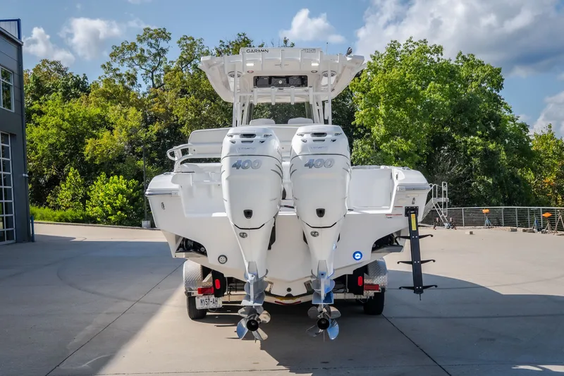 Slide: The Image of 2023 Fountain 34 Tournament Edition boat with dual 400 horsepower engines, parked outdoors. - 24