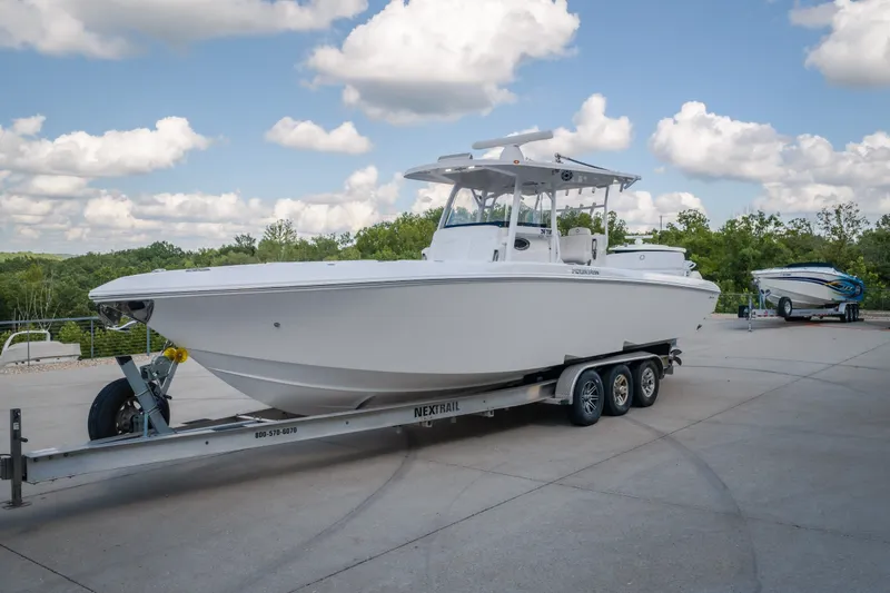 Slide: The Image of 2023 Fountain 34 Tournament Edition boat on trailer under a cloudy sky. - 19