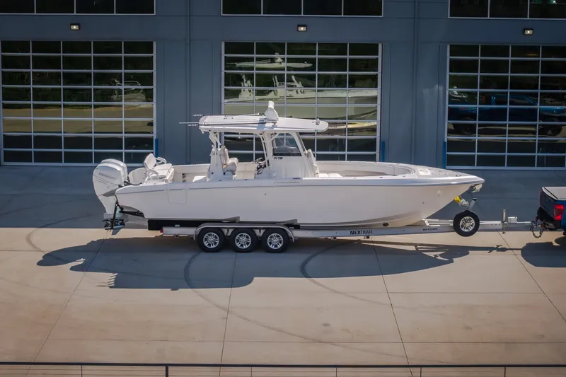 Slide: The Image of 2023 Fountain 34 Tournament Edition boat on trailer outside a modern building. - 20