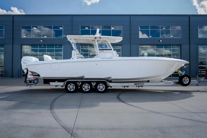 The Image of 2023 Fountain 34 Tournament Edition boat on trailer, parked outside modern building. - 15