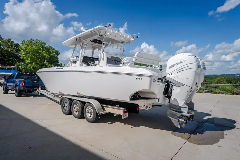 Slide: The Image of 2023 Fountain 34 Tournament Edition boat on trailer, featuring dual Mercury engines. - 34