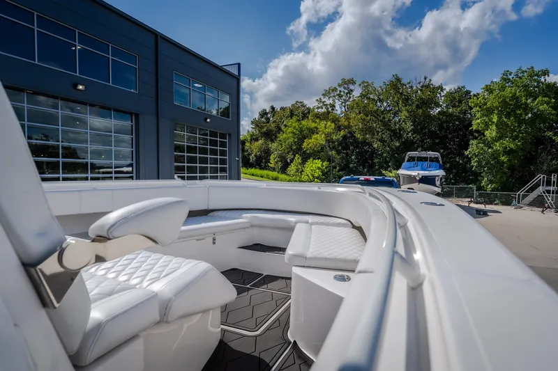 Slide: The Image of 2023 Fountain 34 Tournament Edition boat with luxurious seating, parked near a modern building. - 61