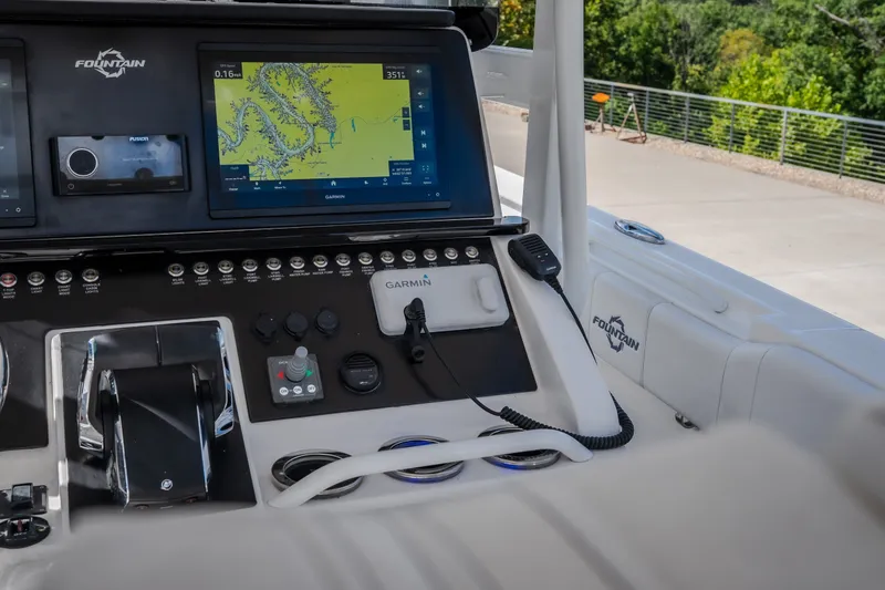 Slide: The Image of Control panel of 2023 Fountain 34 Tournament Edition boat with navigation screens and controls. - 51