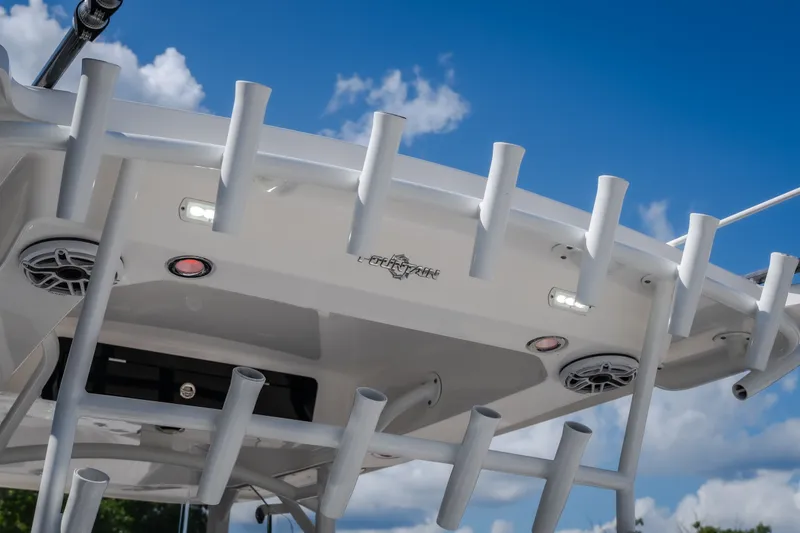 Slide: The Image of 2023 Fountain 34 Tournament Edition boat with rod holders and speakers under a blue sky. - 46