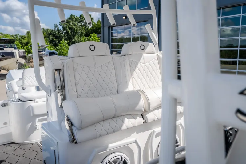 Slide: The Image of Luxury seating on 2023 Fountain 34 Tournament Edition boat, featuring white quilted upholstery. - 56