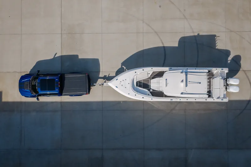 Slide: The Image of Overhead view of a 2023 Fountain 34 Tournament Edition boat towed by a blue truck. - 29