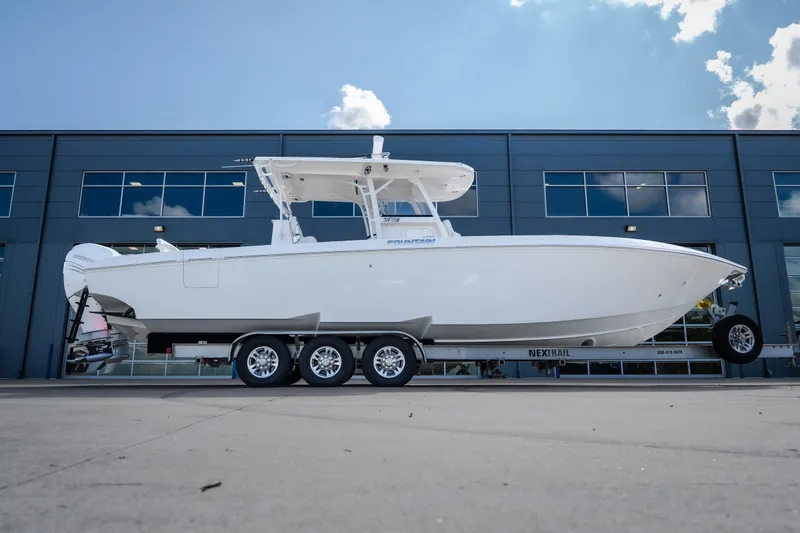 Slide: The Image of 2023 Fountain 34 Tournament Edition boat on trailer, parked outside modern building. - 28