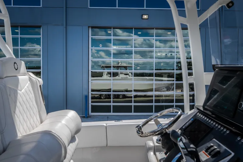 Slide: The Image of 2023 Fountain 34 Tournament Edition boat interior with reflection on glass building. - 54