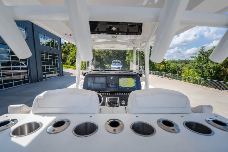 Slide: The Image of 2023 Fountain 34 Tournament Edition boat cockpit with advanced navigation system and rod holders. - 49