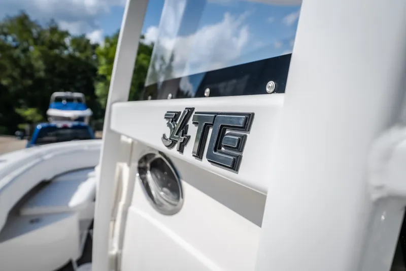 Slide: The Image of 2023 Fountain 34 Tournament Edition boat with "34 TE" emblem, close-up view. - 88