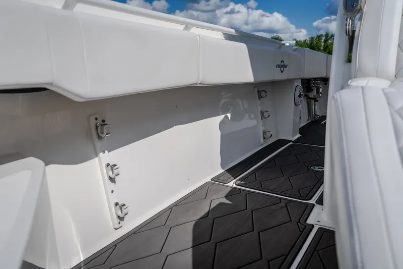 Slide: The Image of 2023 Fountain 34 Tournament Edition boat interior with sleek white seating and modern flooring. - 75