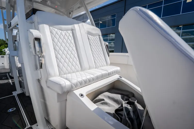 Slide: The Image of Luxurious seating on 2023 Fountain 34 Tournament Edition boat with storage compartment open. - 63