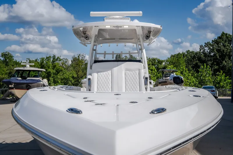 Slide: The Image of 2023 Fountain 34 Tournament Edition boat, sleek design, docked under blue sky. - 71