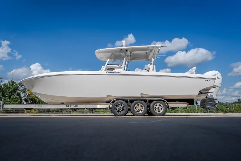 Slide: The Image of 2023 Fountain 34 Tournament Edition boat on trailer under blue sky. - 26