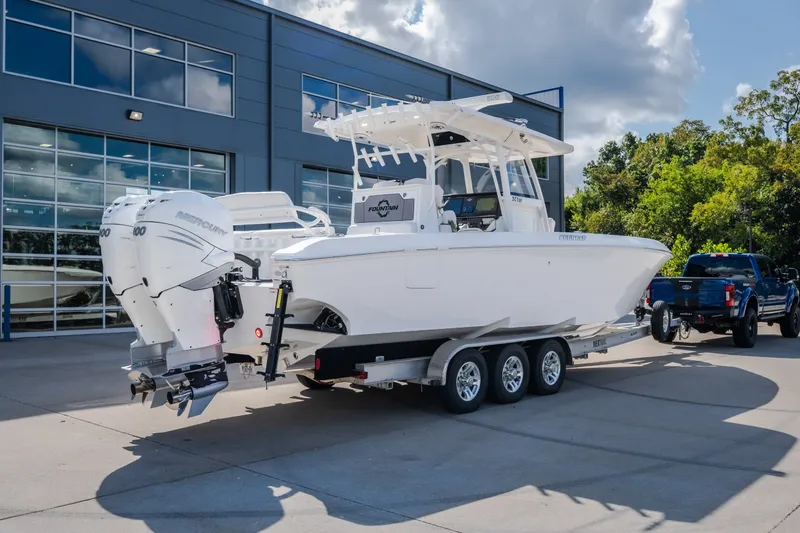 Slide: The Image of 2023 Fountain 34 Tournament Edition boat on trailer, parked outside a modern building. - 25
