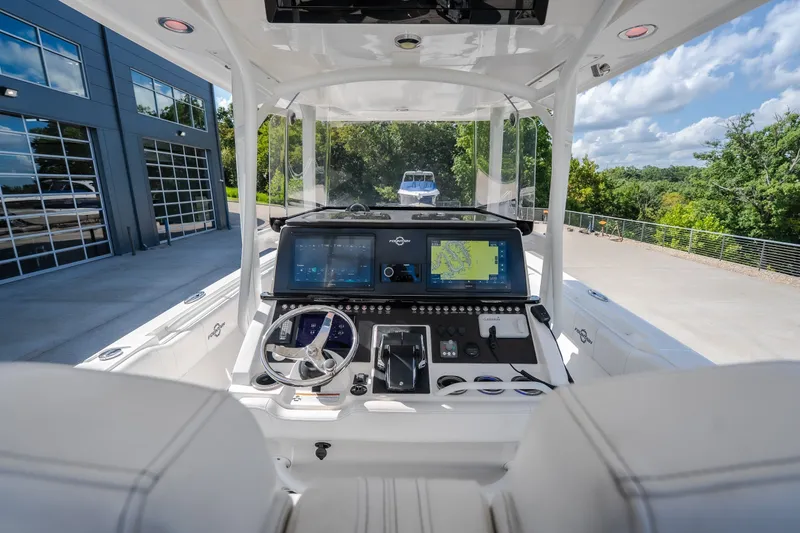 Slide: The Image of 2023 Fountain 34 Tournament Edition boat cockpit with advanced navigation displays and steering wheel. - 48
