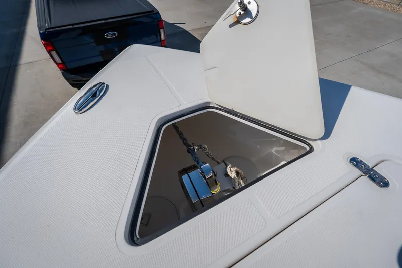 Slide: The Image of Open anchor hatch on 2023 Fountain 34 Tournament Edition boat, with visible chain and rope. - 68