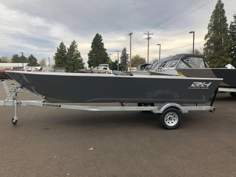 Slide: The Image of 2024 RH Boats Pro V 18 on Karavan trailer, parked outdoors. - 11