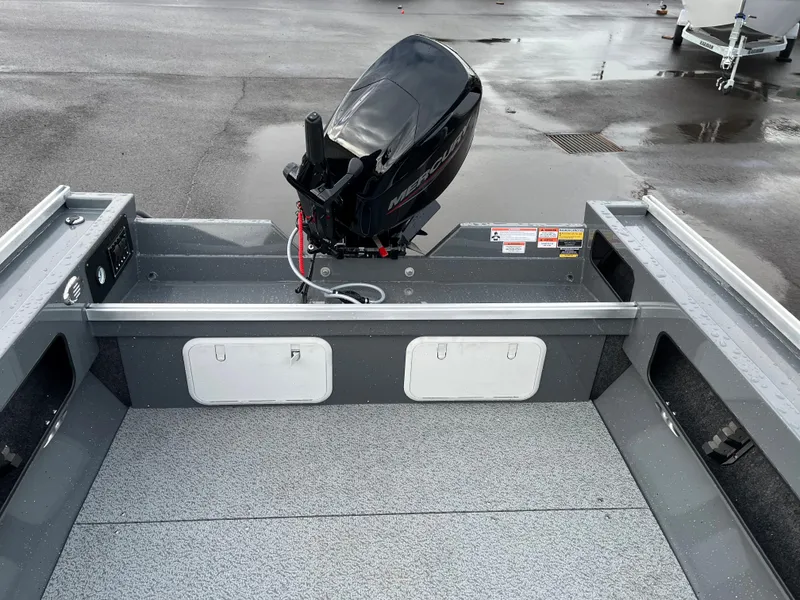 Slide: The Image of 2024 RH Boats Pro V 18 with outboard motor on wet dock. - 4