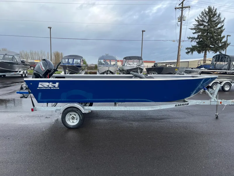 Slide: The Image of 2024 RH Boats Pro V 18 on trailer, blue hull, parked in a lot. - 5