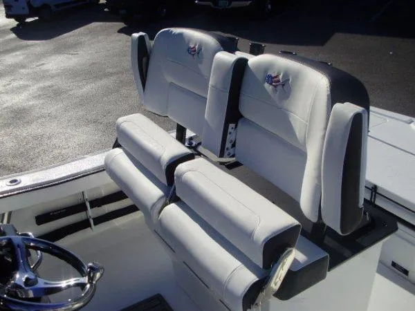 Slide: The Image of 2023 Crevalle 26HCO boat with dual cushioned seats and steering wheel. - 6