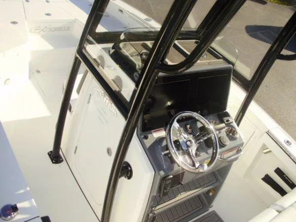 Slide: The Image of 2023 Crevalle 26HCO boat console with steering wheel and controls. - 7