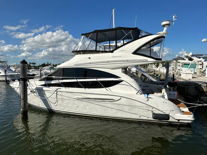 The Image of 2007 Meridian 391 Sedan yacht docked at marina under blue sky. - 0