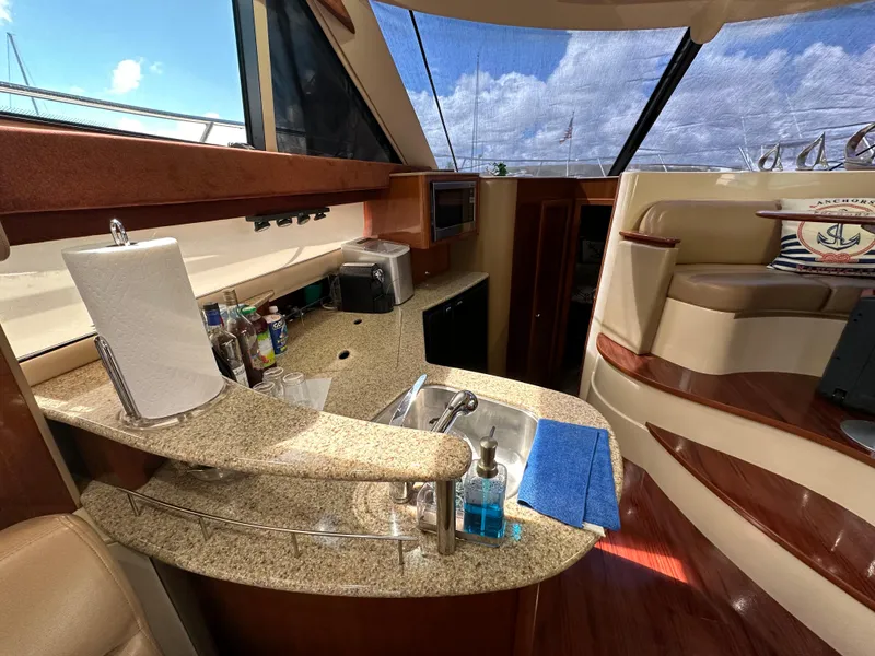 Slide: The Image of Interior of 2007 Meridian 391 Sedan yacht with kitchen and seating area. - 10