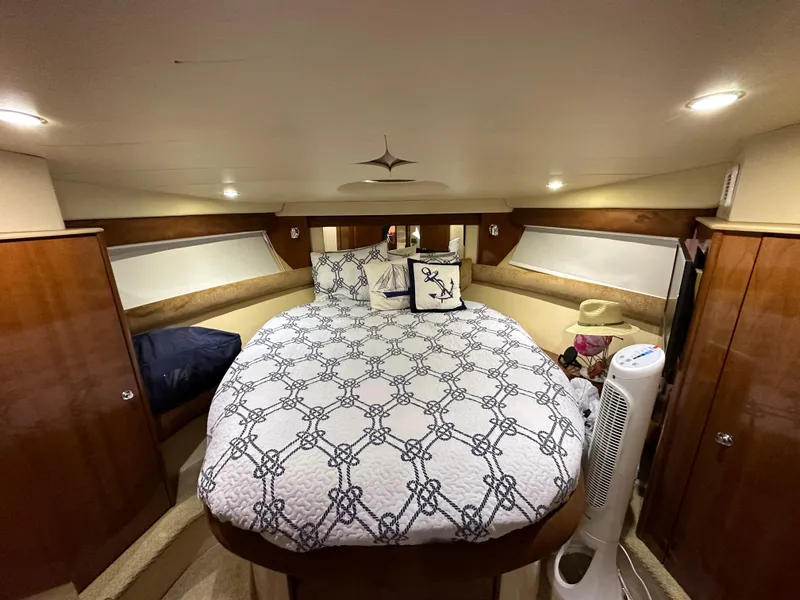 Slide: The Image of Luxurious bedroom in 2007 Meridian 391 Sedan yacht with nautical-themed bedding. - 13