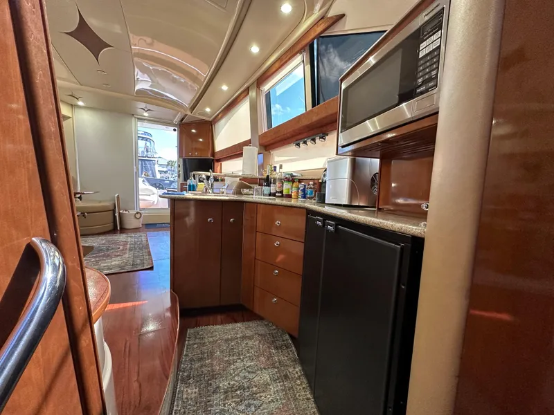 Slide: The Image of 2007 Meridian 391 Sedan yacht interior kitchen with modern appliances and wooden cabinetry. - 14