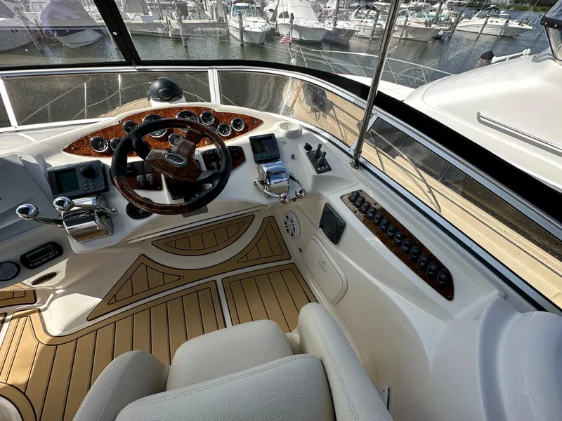 Slide: The Image of 2007 Meridian 391 Sedan helm station with wood accents and marina view. - 22