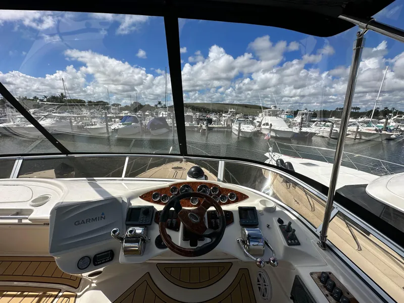 Slide: The Image of 2007 Meridian 391 Sedan helm with marina view, featuring Garmin navigation system. - 23