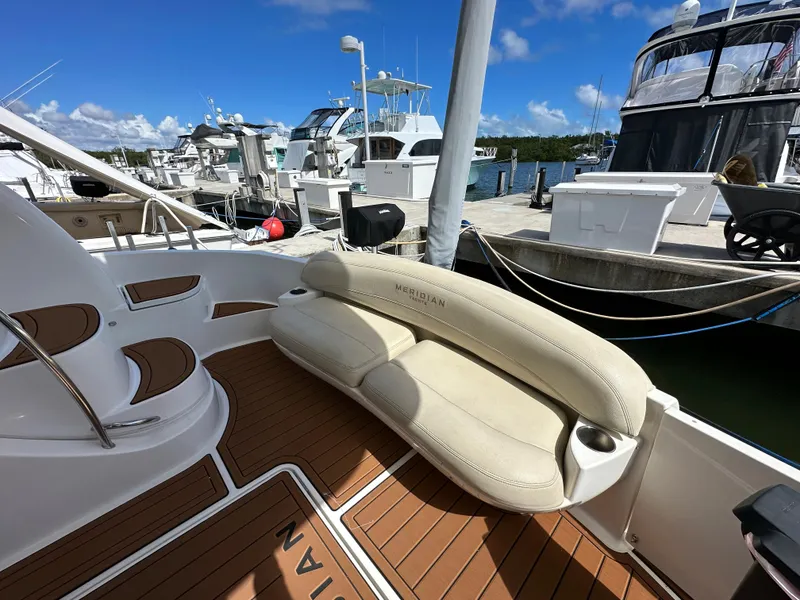 Slide: The Image of 2007 Meridian 391 Sedan yacht at marina with cushioned seating and teak deck. - 3
