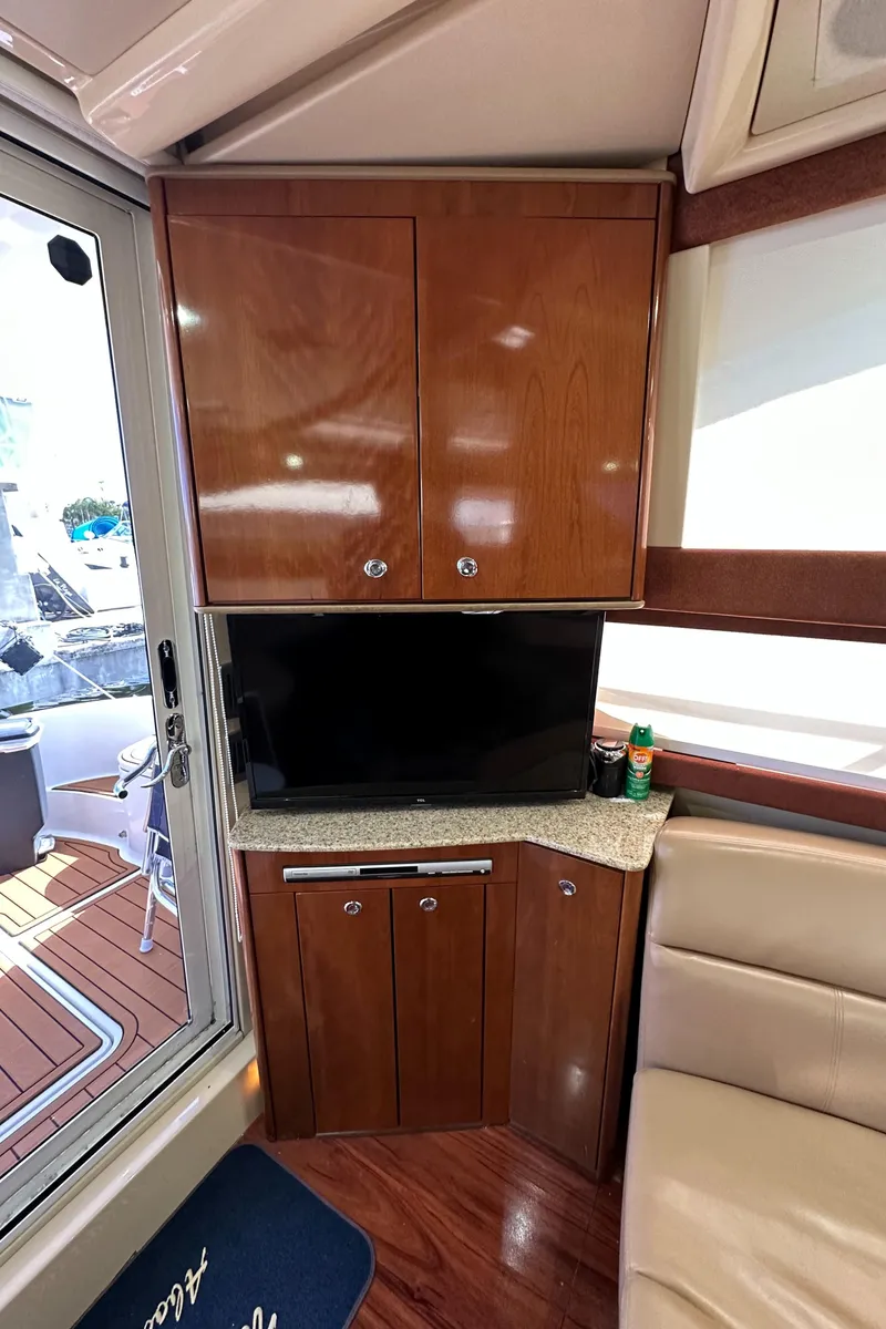Slide: The Image of 2007 Meridian 391 Sedan interior with TV and wooden cabinetry. - 32