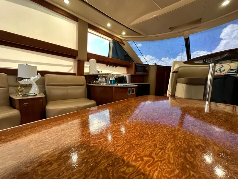 Slide: The Image of Luxurious interior of a 2007 Meridian 391 Sedan yacht with polished wood table. - 8
