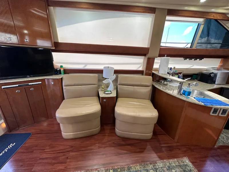 Slide: The Image of Luxurious interior of a 2007 Meridian 391 Sedan yacht with leather seating and wooden cabinetry. - 9