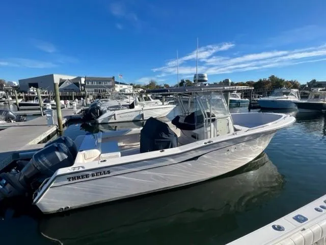 The Image of 2001 Grady-White Bimini 306 boat docked in marina under clear blue sky. - 0