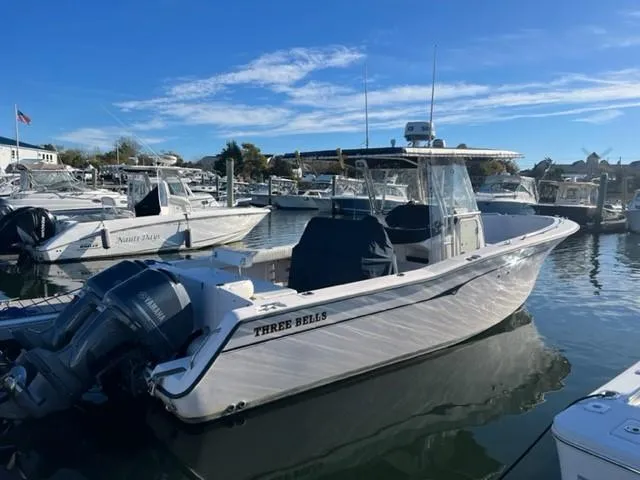 Slide: The Image of 2001 Grady-White Bimini 306 boat docked in a marina under clear blue skies. - 1