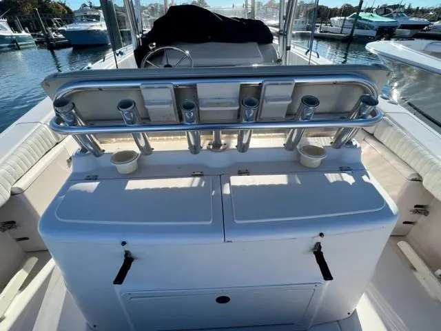 Slide: The Image of 2001 Grady-White Bimini 306 boat interior with rod holders and seating. - 12