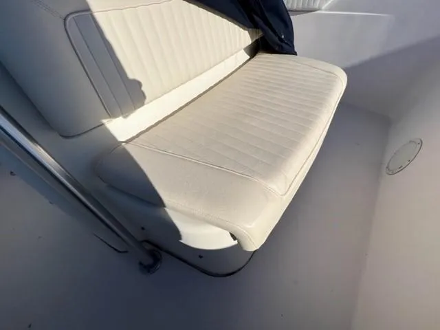Slide: The Image of 2001 Grady-White Bimini 306 boat seat with white upholstery and metal railing. - 4