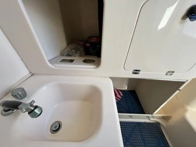 Slide: The Image of 2001 Grady-White Bimini 306 boat interior with sink and storage compartments. - 5